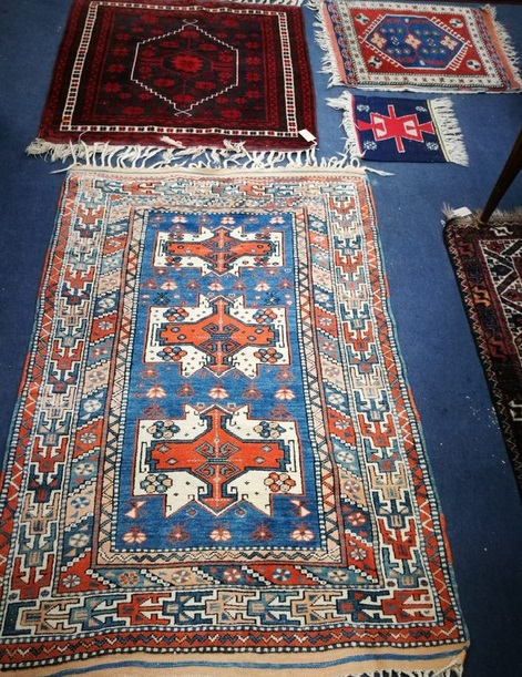 Four small Oriental rugs 152 x 103cm, 100 x 100cm, 77 x 67cm and 35 x 38cm